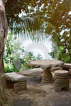 Small patio with stone table and chairs