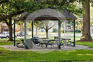 A small pavilion in a city park is ready for a day of picnics
