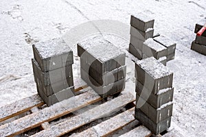 Small paving slabs covered with snow at a construction site
