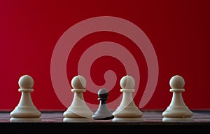 Small pawn on chess board against larger adversary concept of adversity ,discimination ,equality