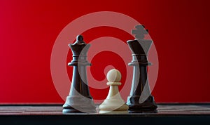 Small pawn on chess board against larger adversary concept of adversity ,discimination ,equality