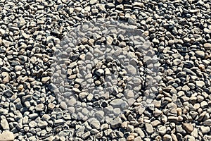 Small pebbles pattern on the beach.Stone background