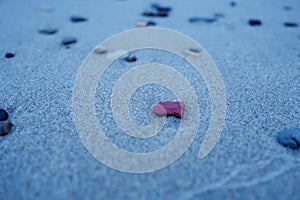 Small pebbles on a sandy beach.