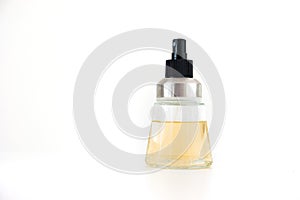Small perfume bottle with pulverizer nozzle half full isolated on white