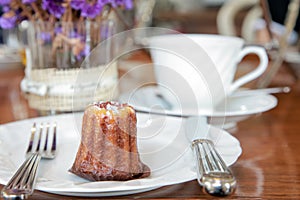 Small piece of canele serve in a plate on the table in tea shop