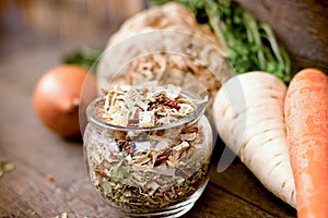 Small pieces of dried vegetables in jar , dry celery, dry ccarrot, dry persley and dry onion