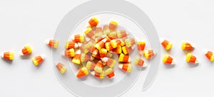 A small pile of candy corn for Halloween, against a white background.