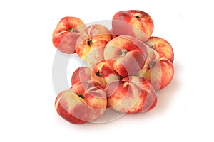 Small pile of flat fig peaches isolated on white