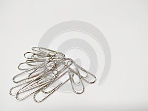 Small pile of paper clips. Silver design isolated on white background.