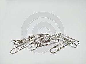 Small pile of paper clips. Silver design isolated on white background.