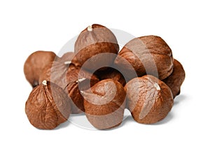 A small pile of peeled hazelnuts on a white isolated background. Side view.Macro