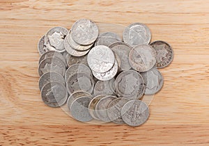 Small pile of silver dimes on a wood table