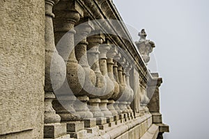 Small pillars supporting an old stone railing vase shaped decoration in Buda palace, Budapest, Hungar