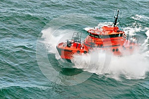 Small pilot boat sailing over the wave