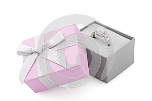 Small pink and gray jewelry gift box with bow isolated on white