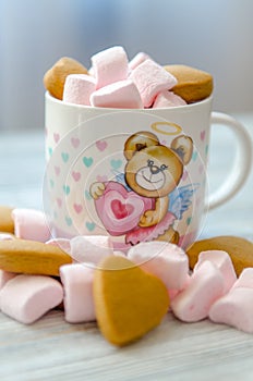 Small pink marshmallow with biscuits in the cup