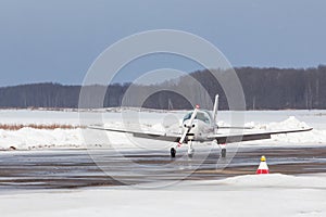 Small plane at the airport in winter