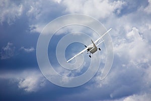 Small plane in blue cloudy sky