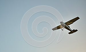 Small Plane Flying with blue sky background