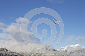 Small plane flying over Alaska in winter