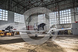 Small plane inside hangar in daylight