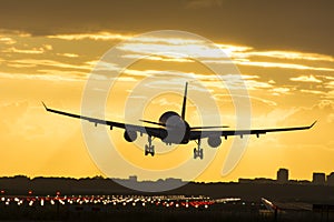 Small plane landing during sunrise.