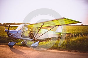 Small plane in the sky and on the field