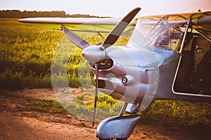 Small plane in the sky and on the field