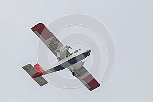 A small plane takes off and takes off on the island of Dune. Background is bright sky photo