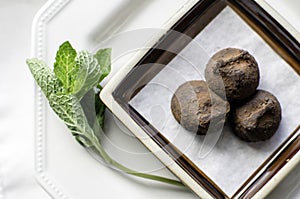 Small plate of chocolate truffles.