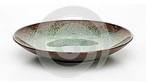 A small plate with a unique drop glaze effect in shades of green and brown resembling a peaceful forest landscape.