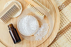 Small plate with white epsom bath salts (foot soak)  bottle of essential oil  wooden hair brush  massage body brush.