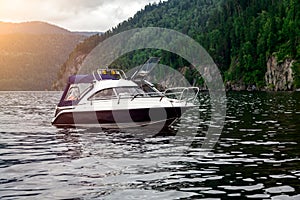 A small pleasure boat with a motor for excursions and relaxation in picturesque places on the water and traveling on a river or