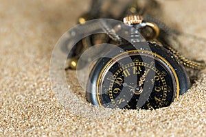 Small Pocket watch in the Sand