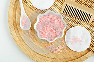 Small porcelain bowl with pink himalayan crystal bath salt foot soak. Homemade spa and beauty