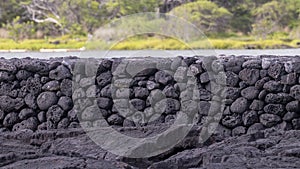 Small portion of the Kaloko Fishpond kuapa or seawall made of interlocking lava rocks on the Big Island, Hawaii.