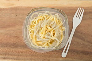 A small portion of linguini pasta in a glass