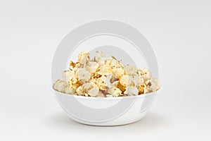 Small portion of popcorn in a white bowl with a white background