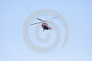 Small private helicopter on a background of blue sky
