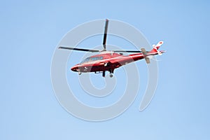 Small private helicopter on a background of blue sky