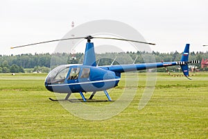 Small private helicopter on grass