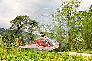 Small private helicopter on grass