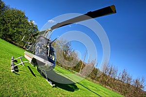 Small private helicopter on grass