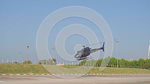 A small private helicopter takes off from an airfield in Dubai.