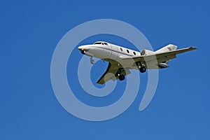 Small private jet on blue sky