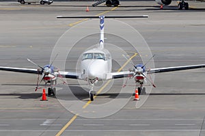 Small private jet turboprop parked, front view