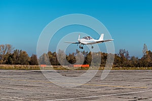 Small private plane in the air. Blue sky