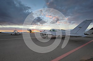 Small private planes parked on the field