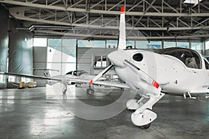 Small private turbo-propeller airplane in hangar