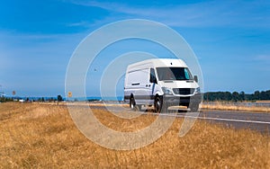 Small pro commercial cargo mini van on spectacular road